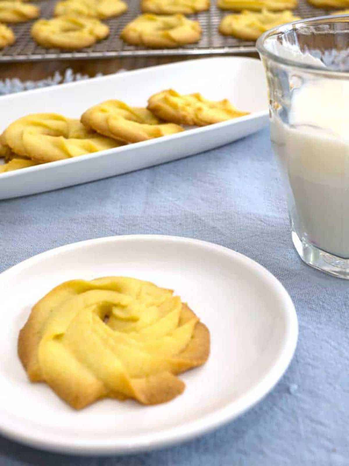 French sables on a plate with milk.