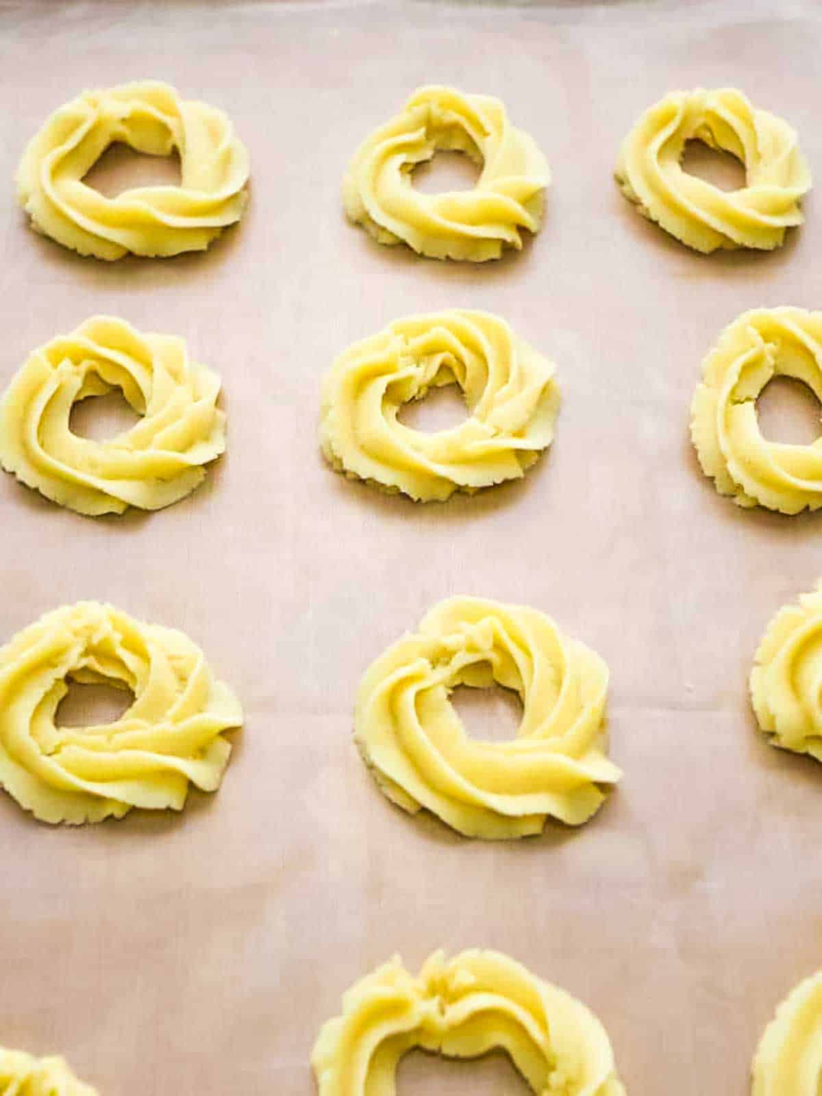 Piping the sable dough into circles.