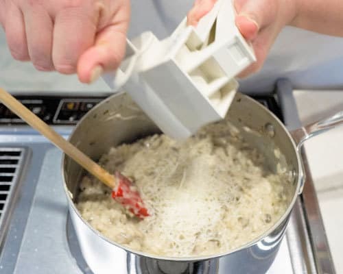 Adding Parmesan cheese