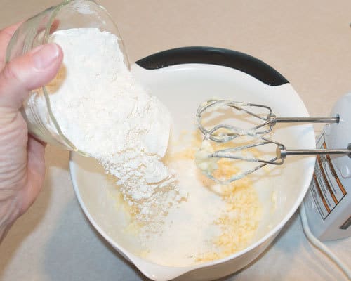 Adding flour to dough 