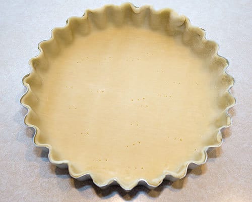 Unbaked pie crust in tart pan