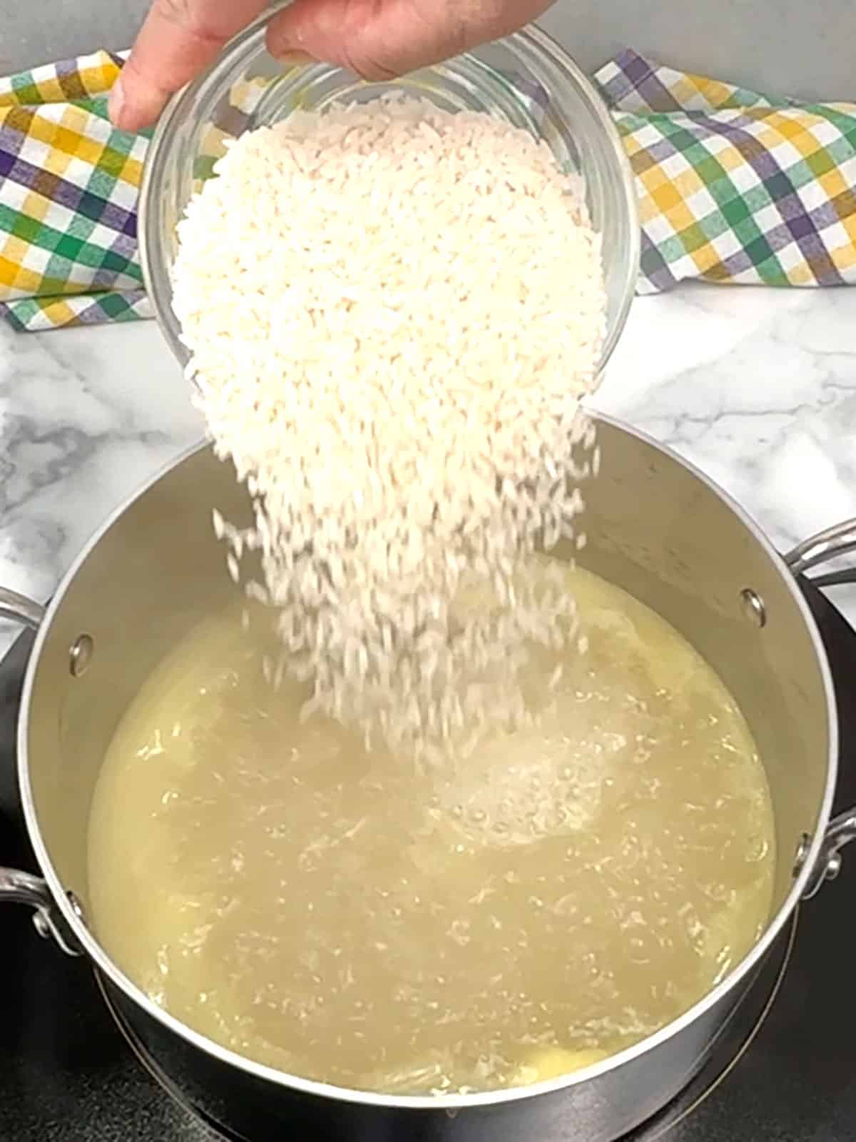 adding rice to boiling water mixture