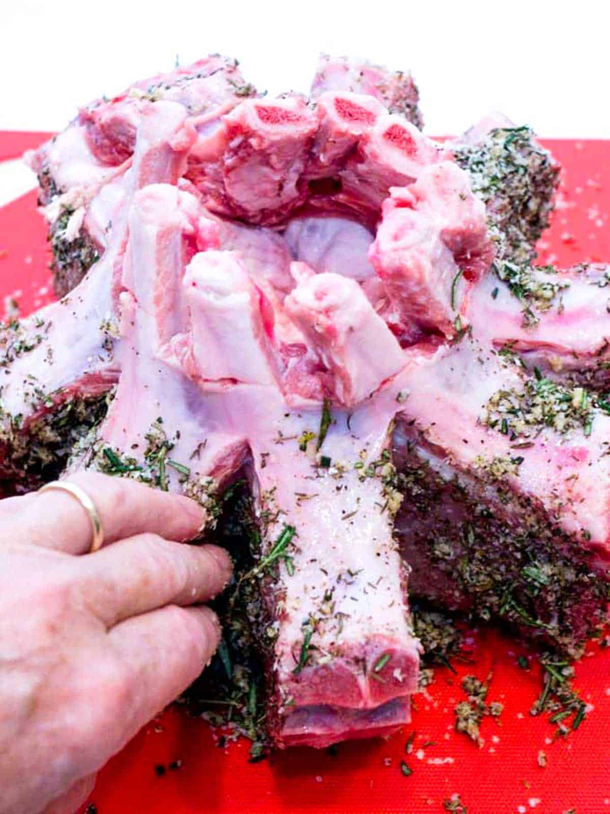 Adding dry rub to the pork.