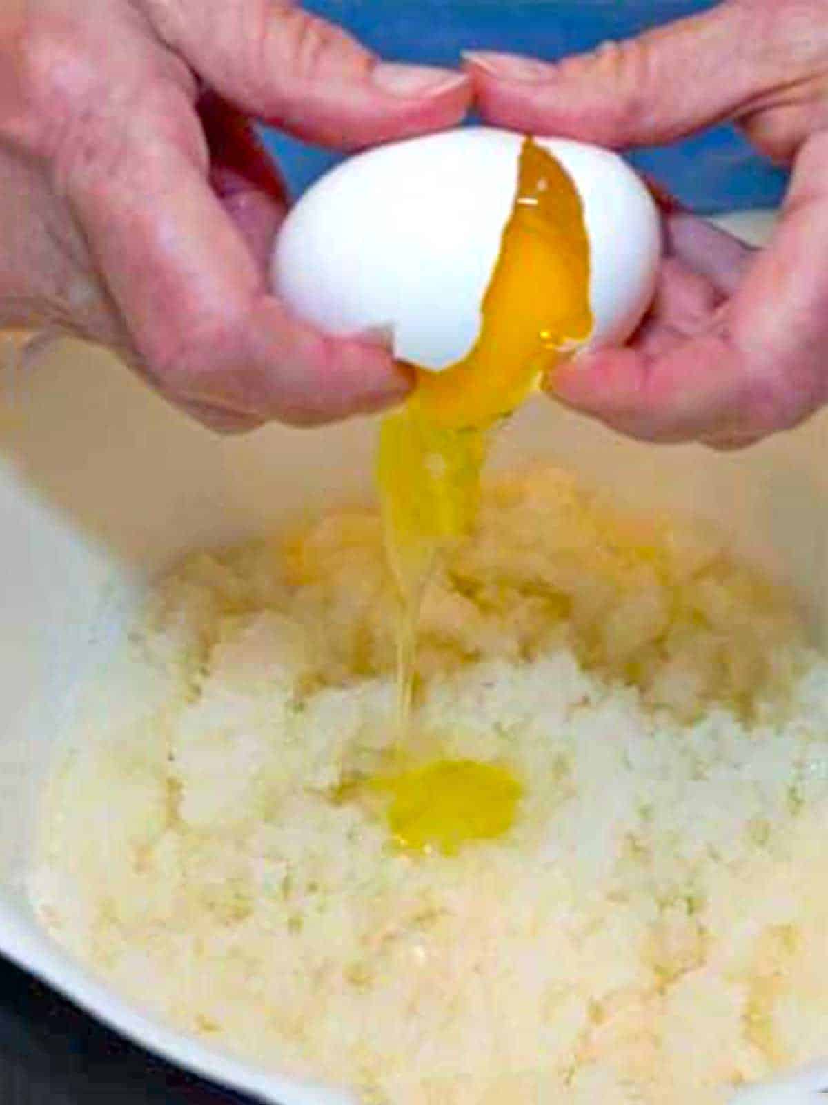 Adding an egg to the sugar and oil.
