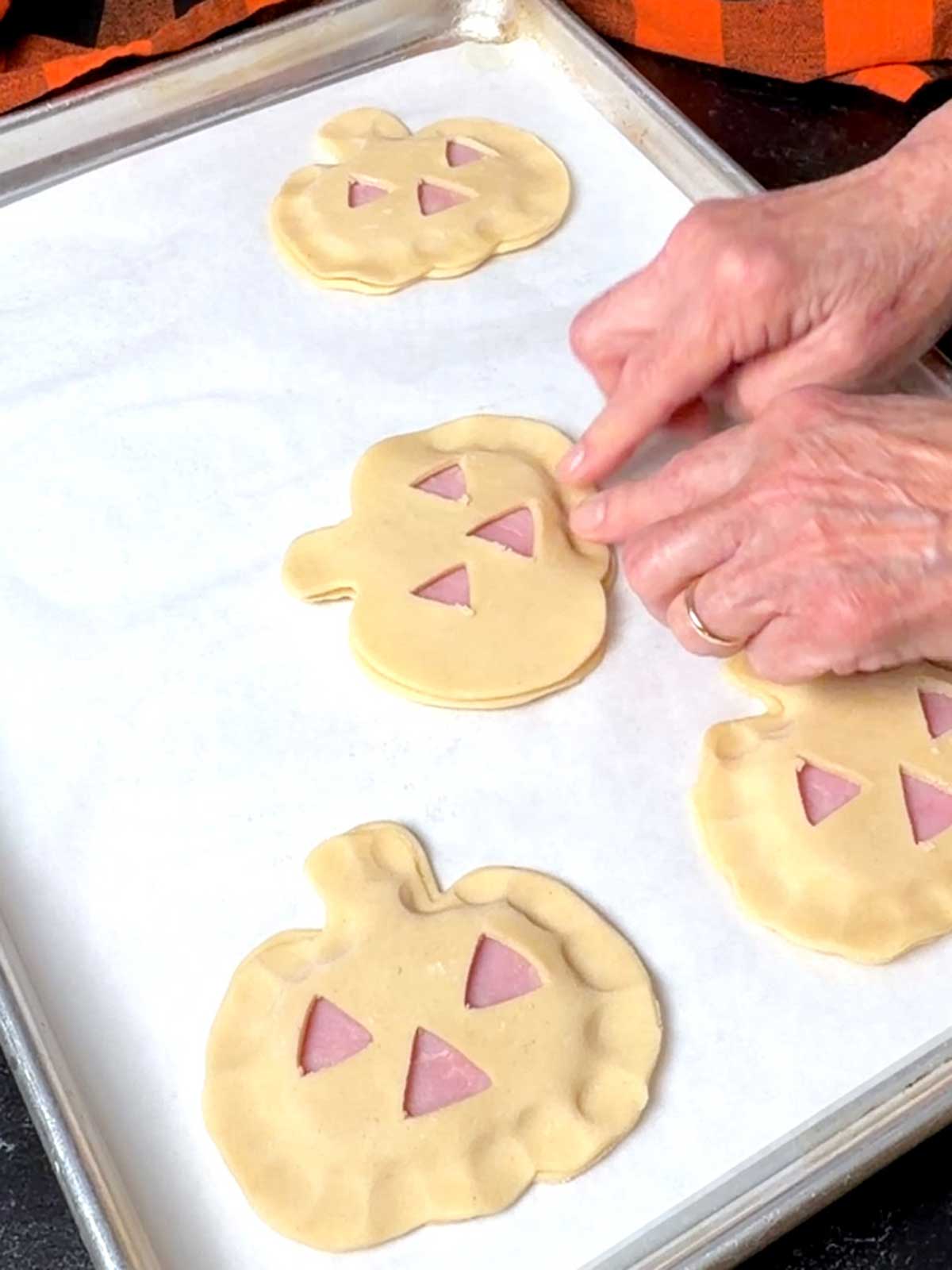 Sealing the pastry with fingers.