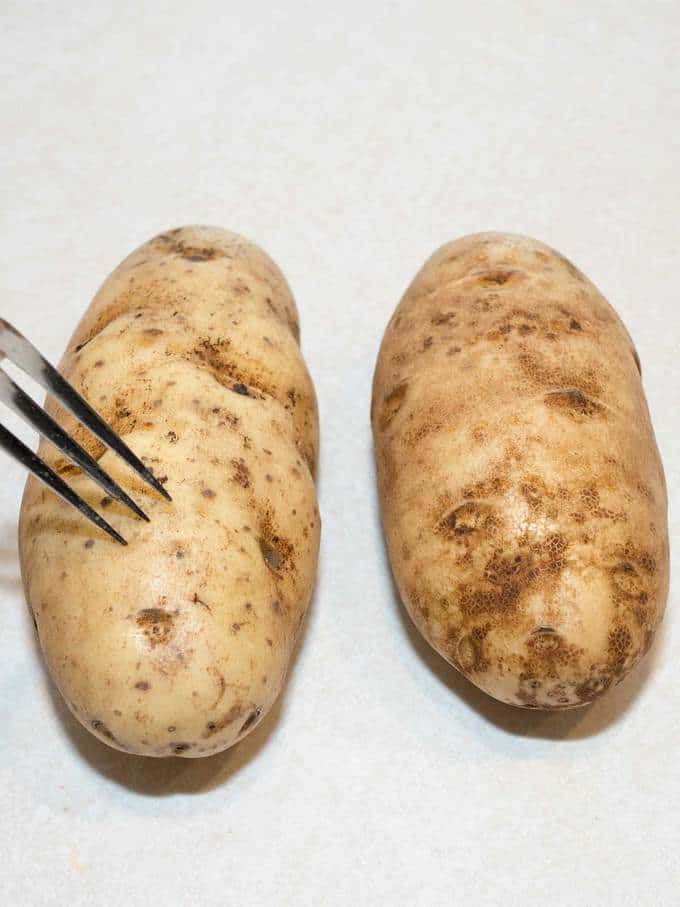 pricking baking potatoes with fork prior to baking