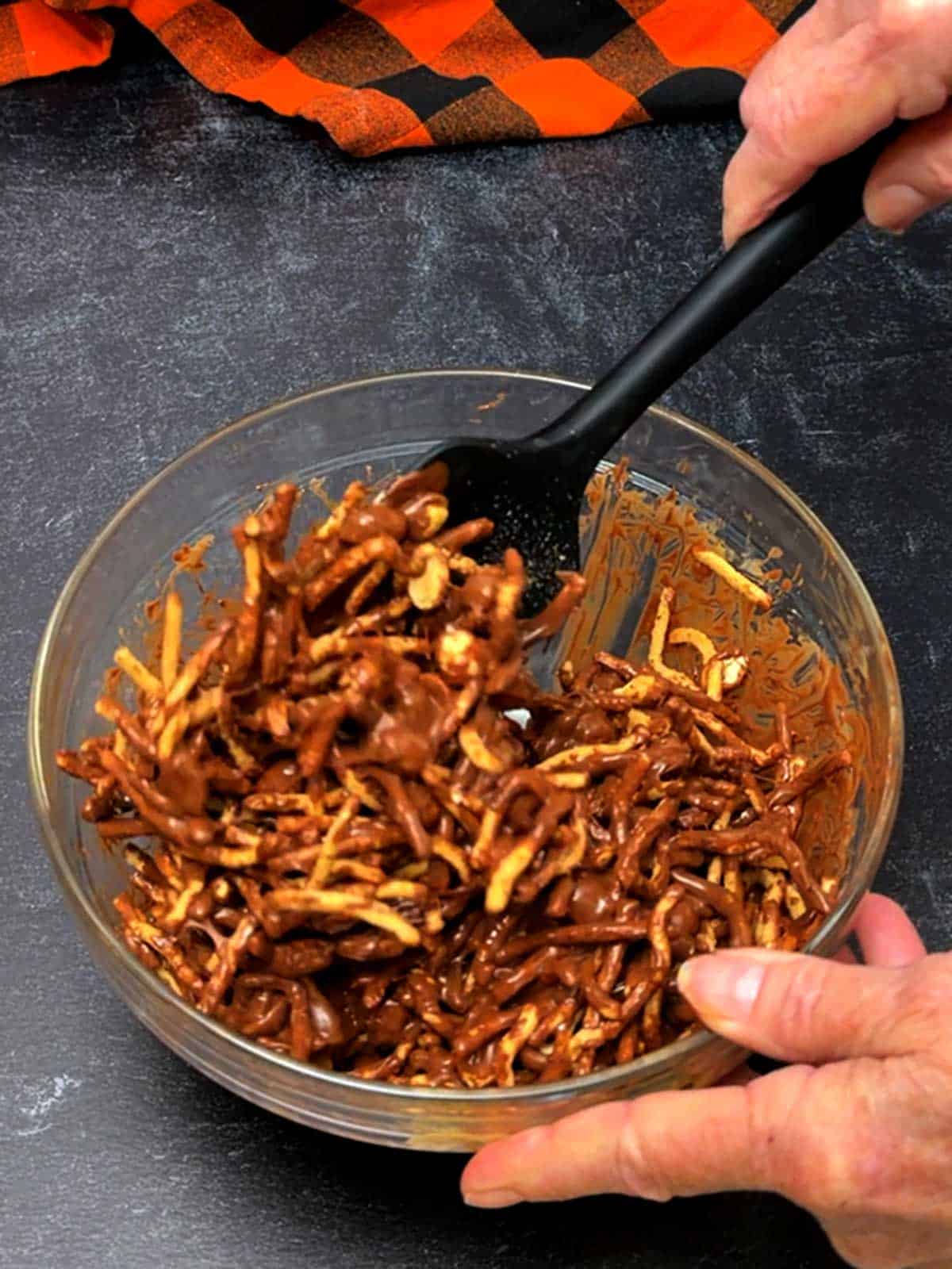 Stirring the ingredients together with a silicone spoon.