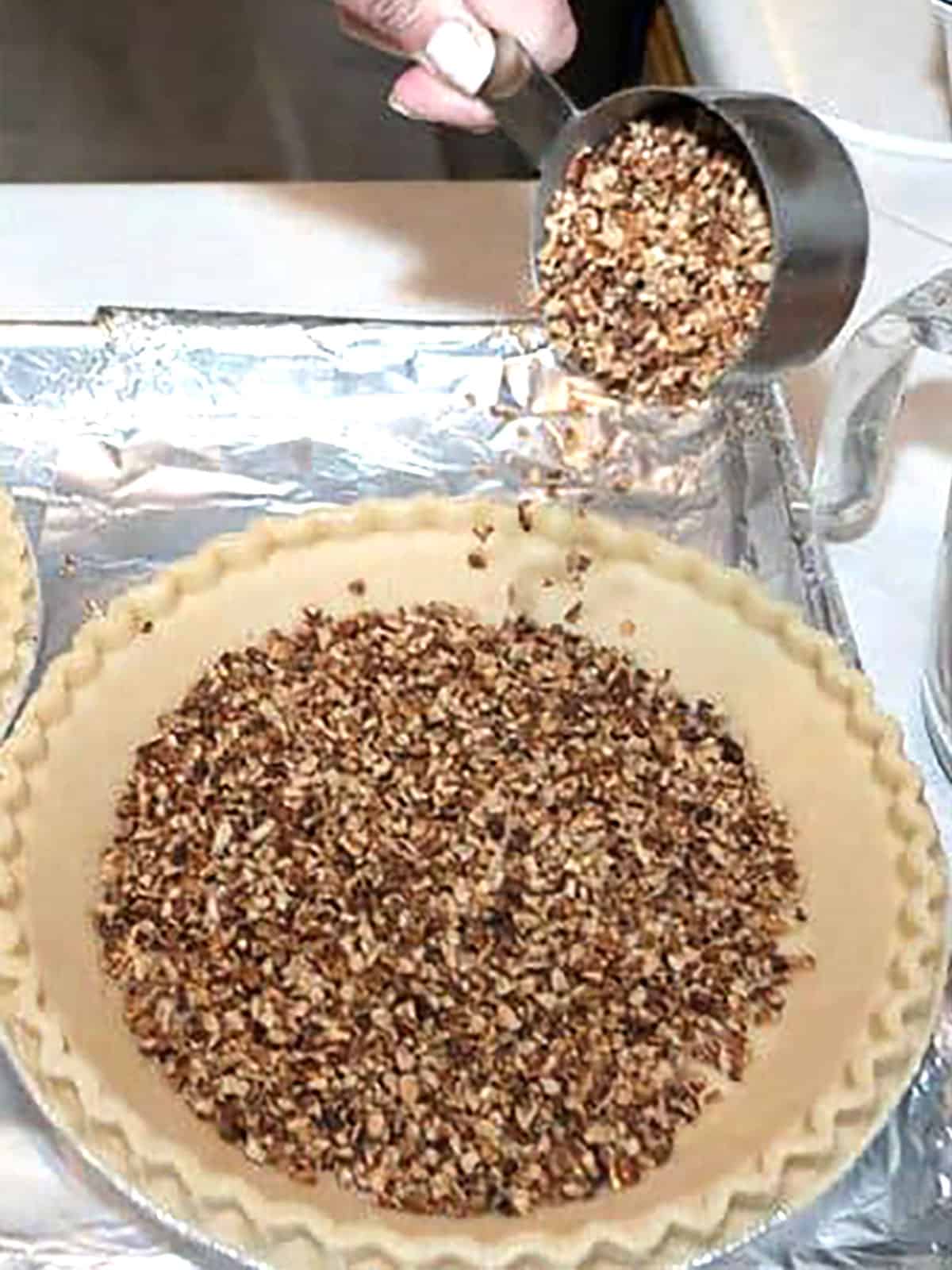 adding toasted pecan pieces to pie shells