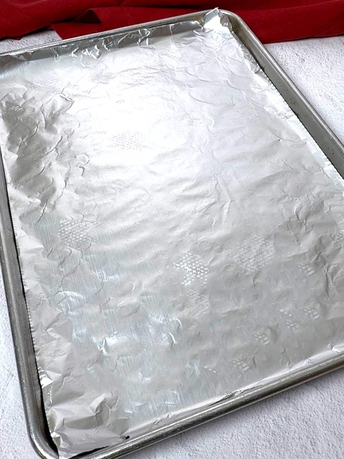 Half sheet pan lined with nonstick foil.