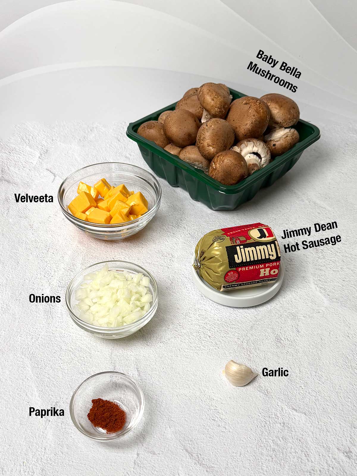 Ingredients for sausage and cheese stuffed mushrooms.