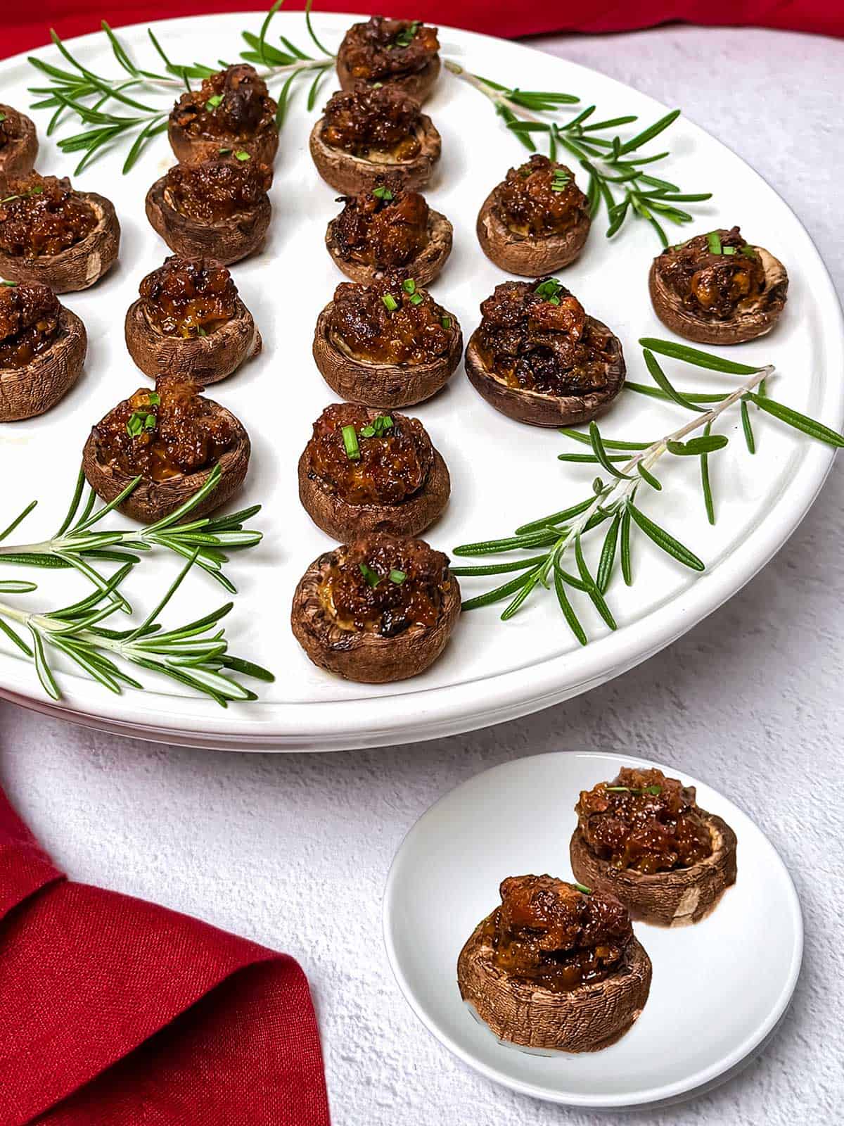 Golden stuffed baby bella mushrooms arranged on a platter