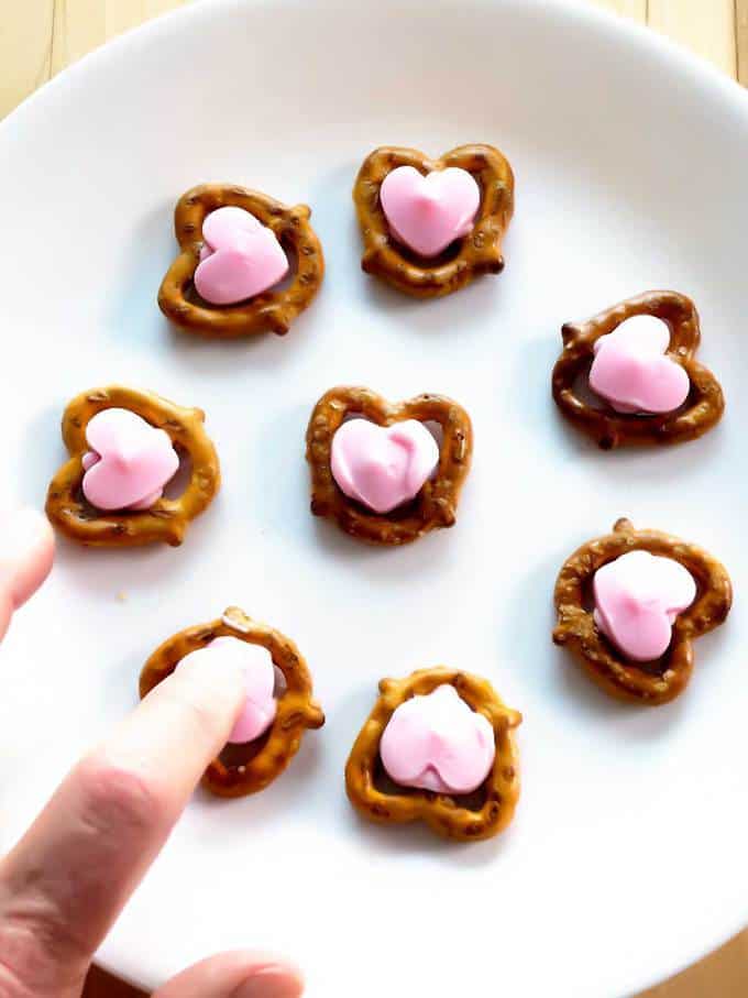 Pressing candy melt onto pretzel