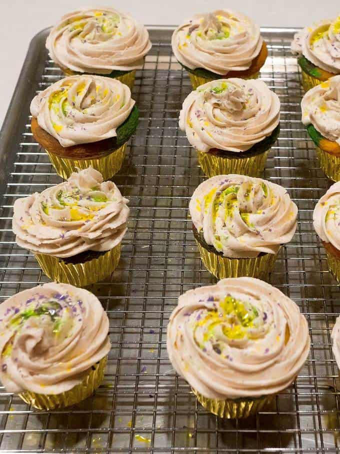 Adding Sprinkles to Mardi Gras Cupcakes with Cinnamon Buttercream Frosting