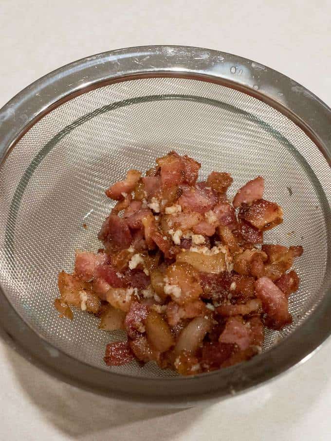 Straining the fat from the bacon