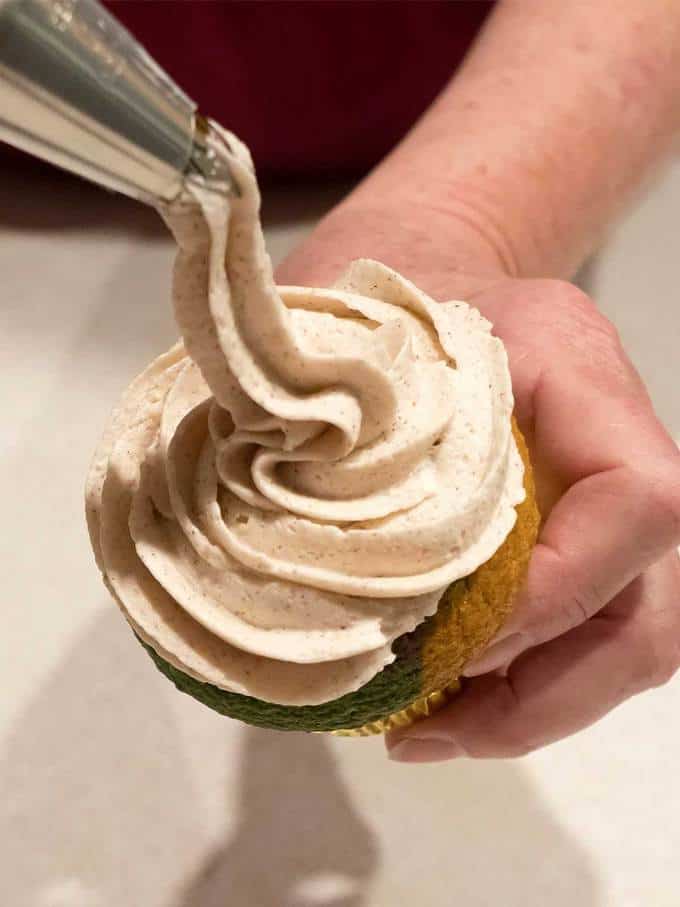 Piping the Frosting for Mardi Gras Cupcakes with Cinnamon Buttercream Frosting