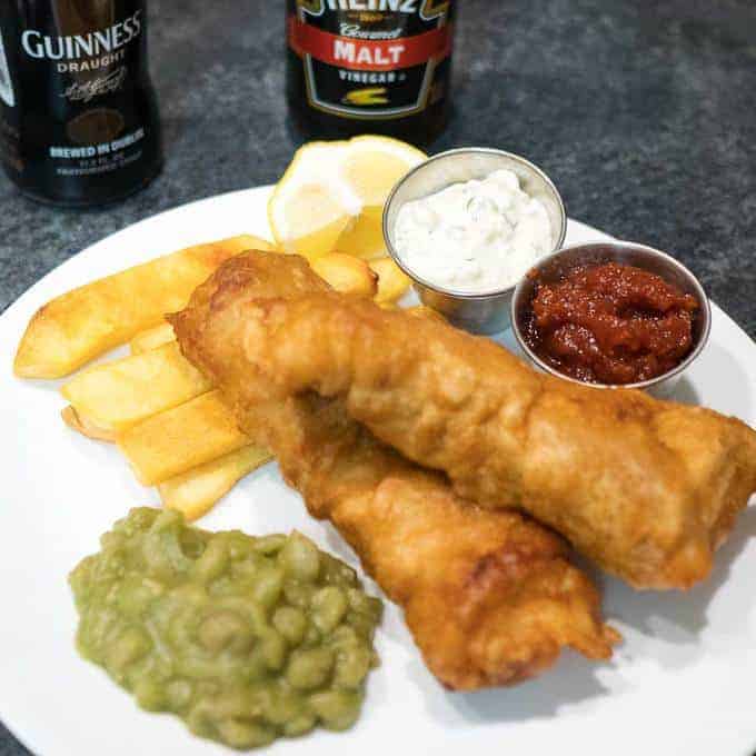 Beer Battered Fish and Chips with Mushy peas is a favorite pub meal. Add homemade tartar sauce, and you have a true winner!