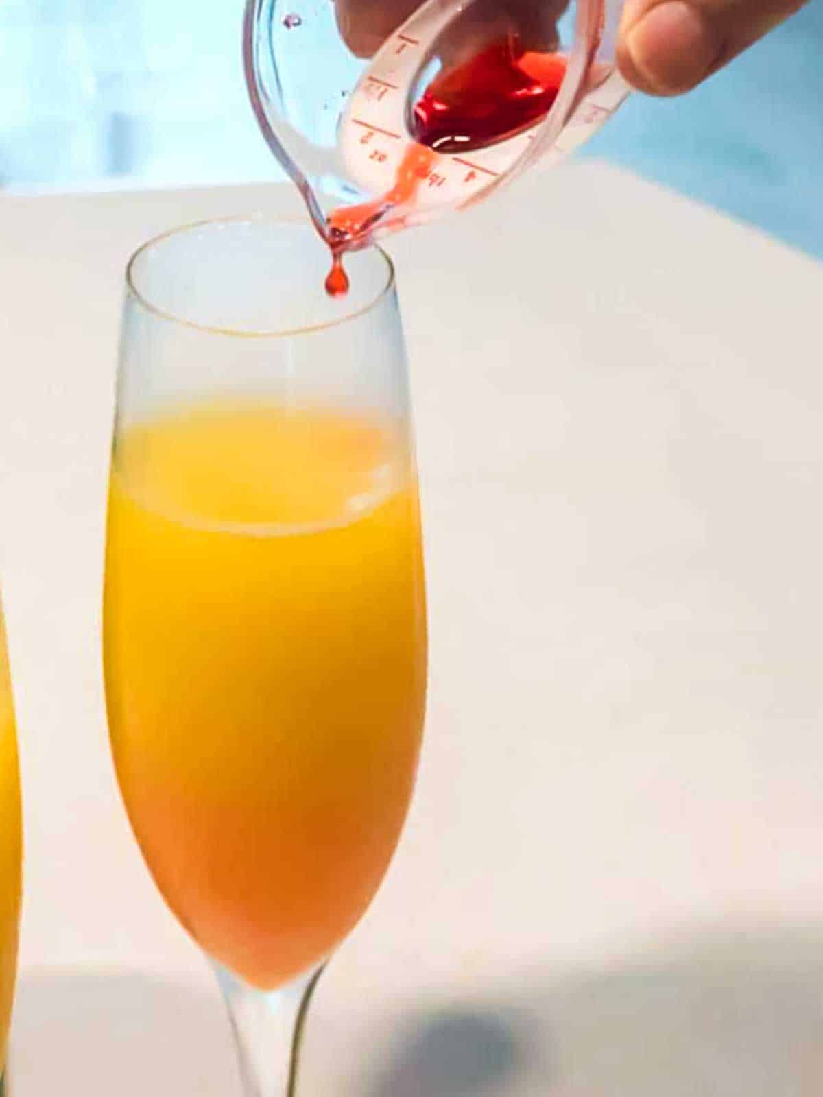 Pouring syrup into glass.