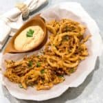 Crispy fried onion strings with spicy dipping sauce