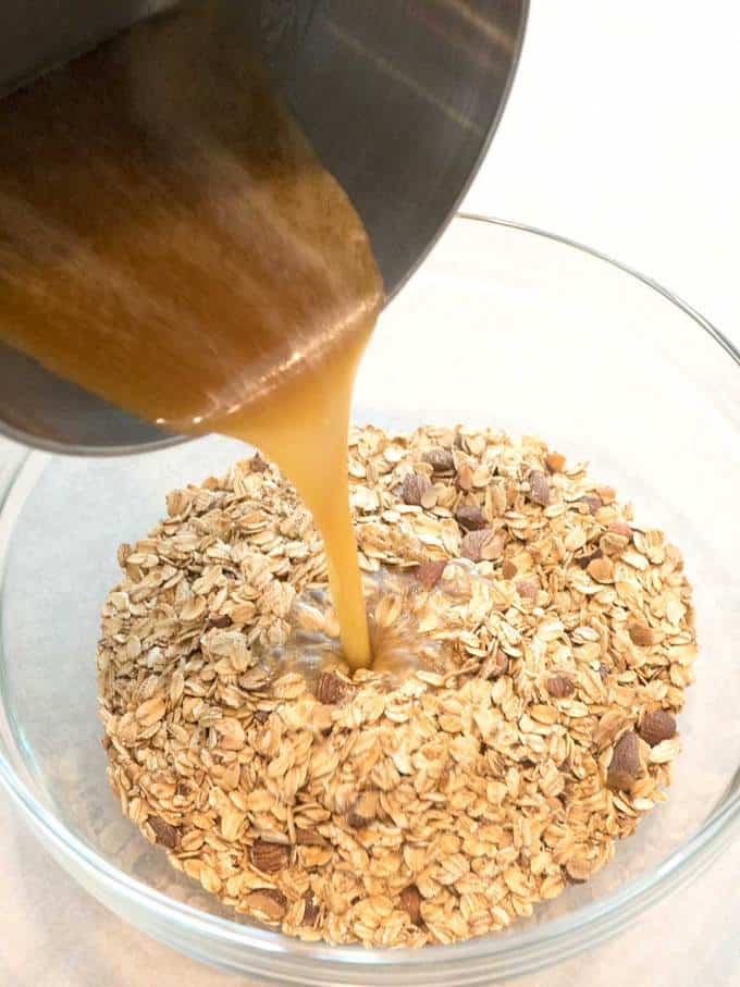 Pouring syrup onto oats and almonds