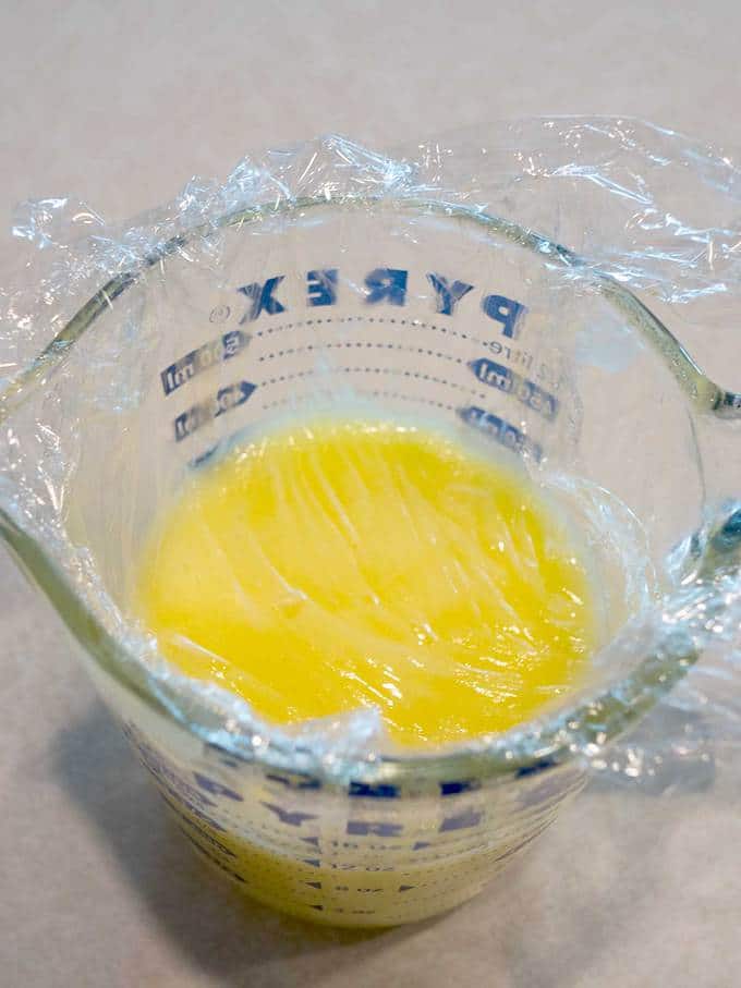 Plastic wrap pressed on lemon curd
