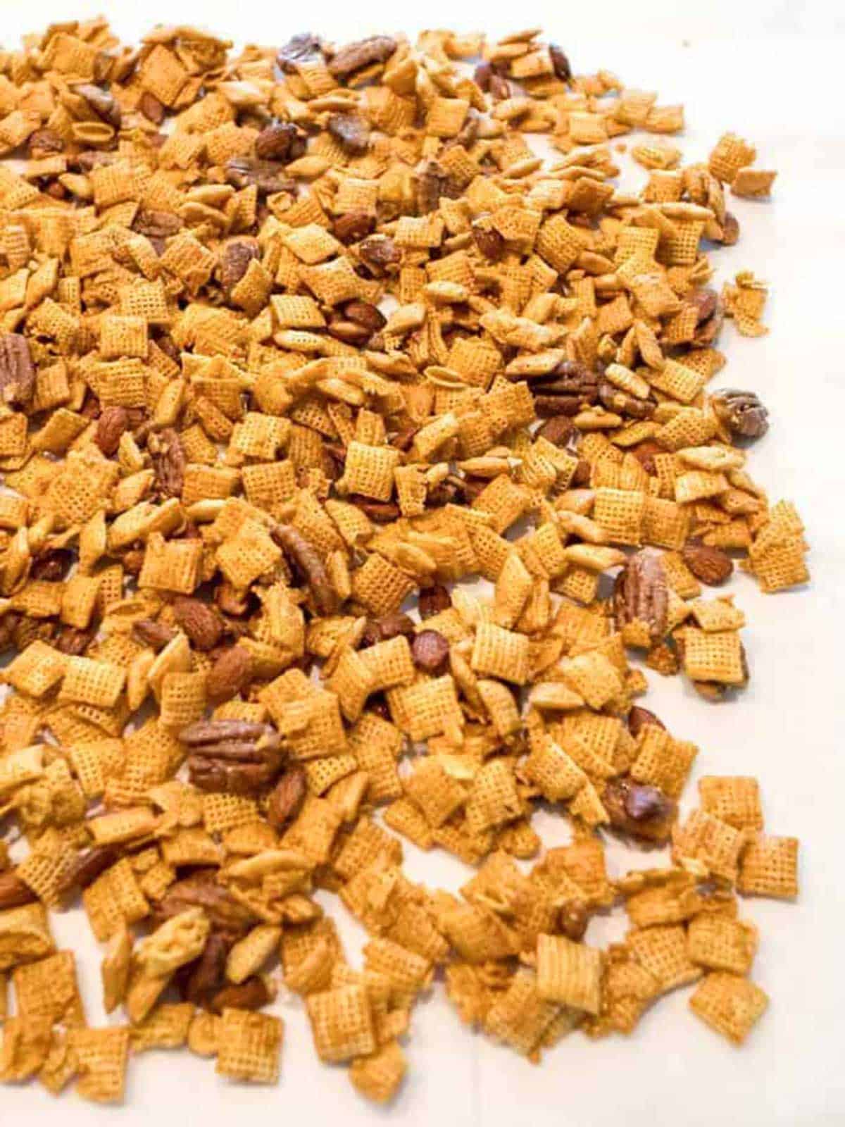 Cooking the Chex mixture on parchment paper.