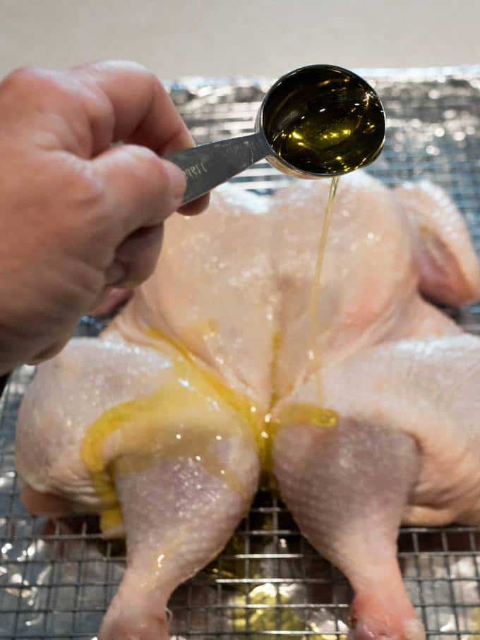 Drizzling Olive Oil on Spatchcock Chicken