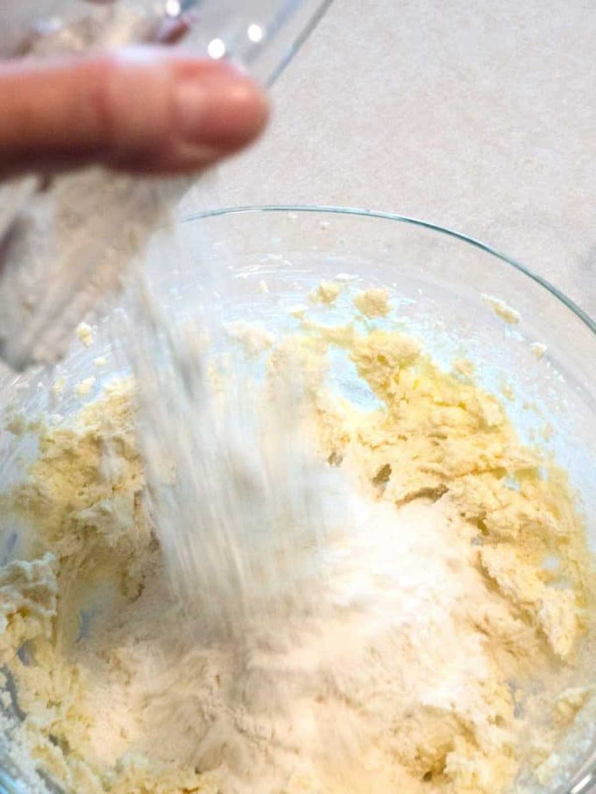Adding all-purpose flour to the cookie dougn.