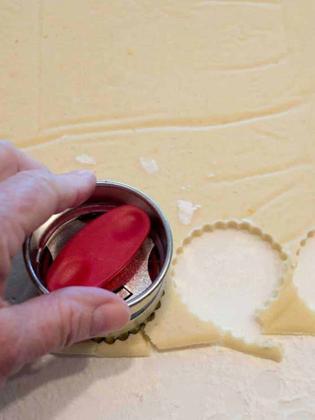 Cutting the linzer cookie rounds.
