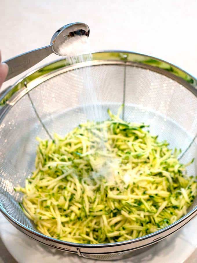Adding salt to zucchini for the Easy Cheesy Zucchini Bites