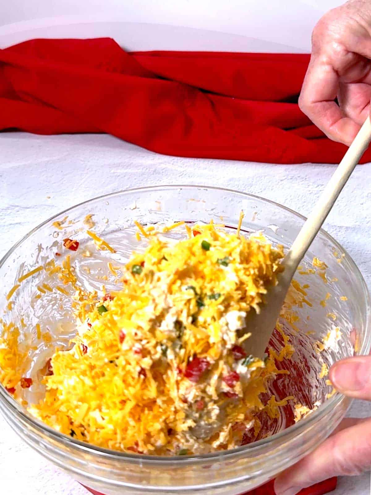 Stirring ingredients together for pimento cheese.