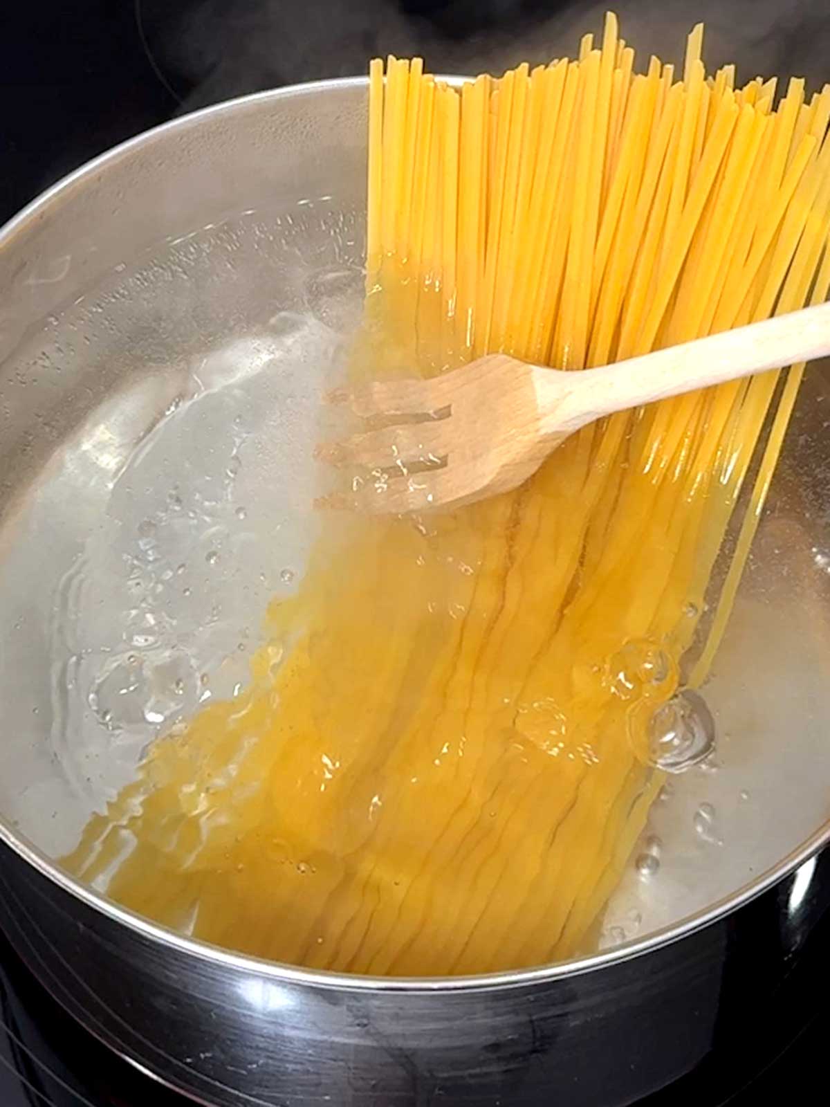 Linguine added to boiling water.
