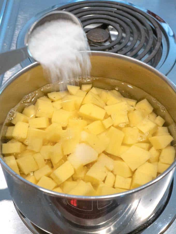 Adding Salt to the potatoes before boiling them