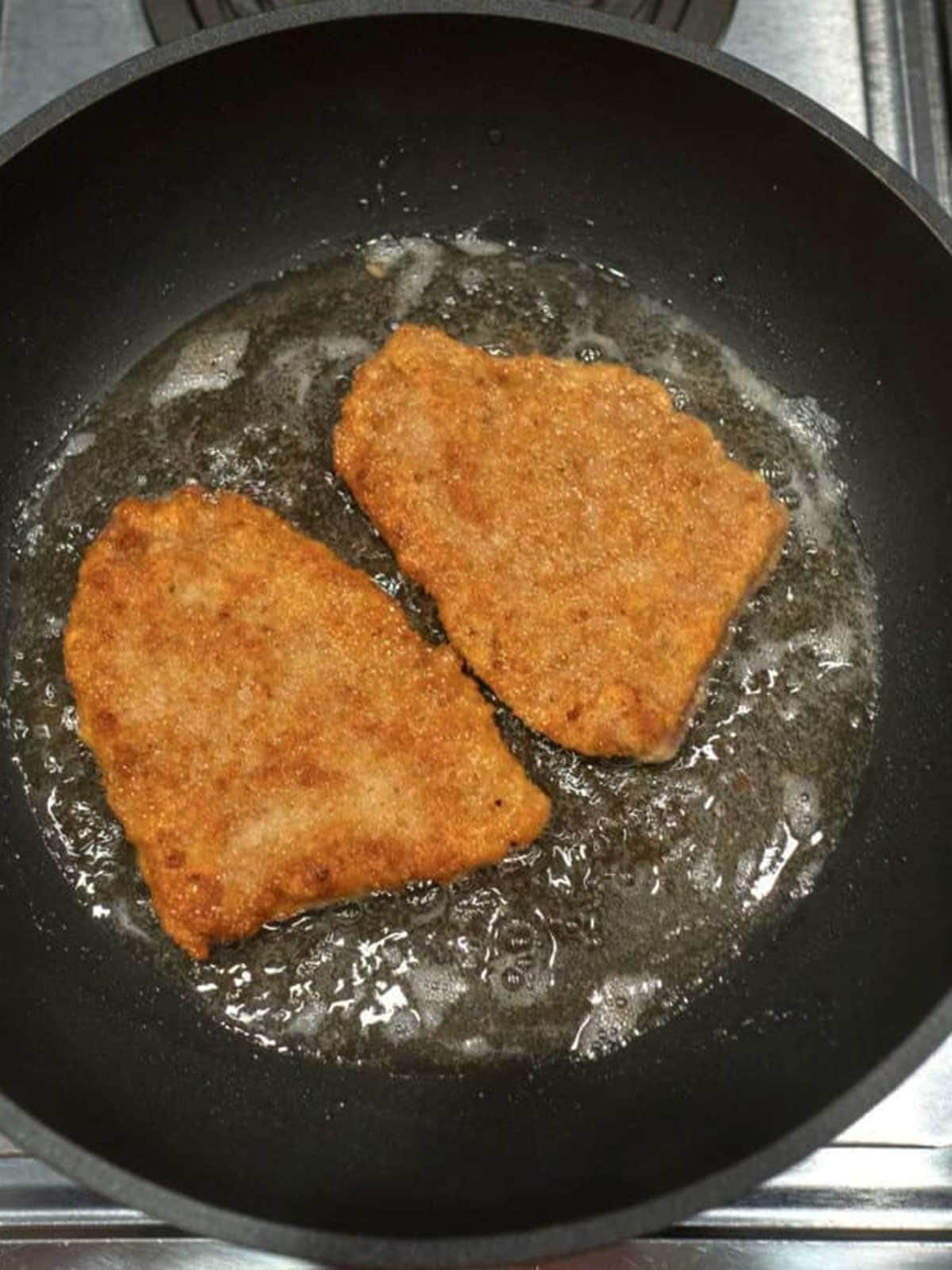 Cooking the pork in a skillet.