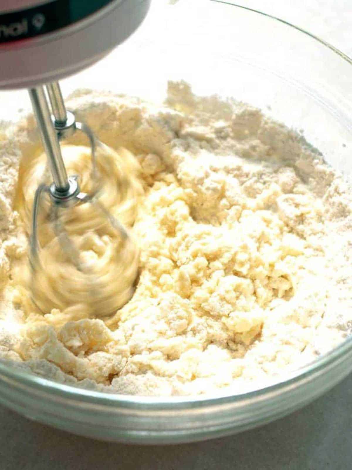 Beating the flour.into the cookie dough.