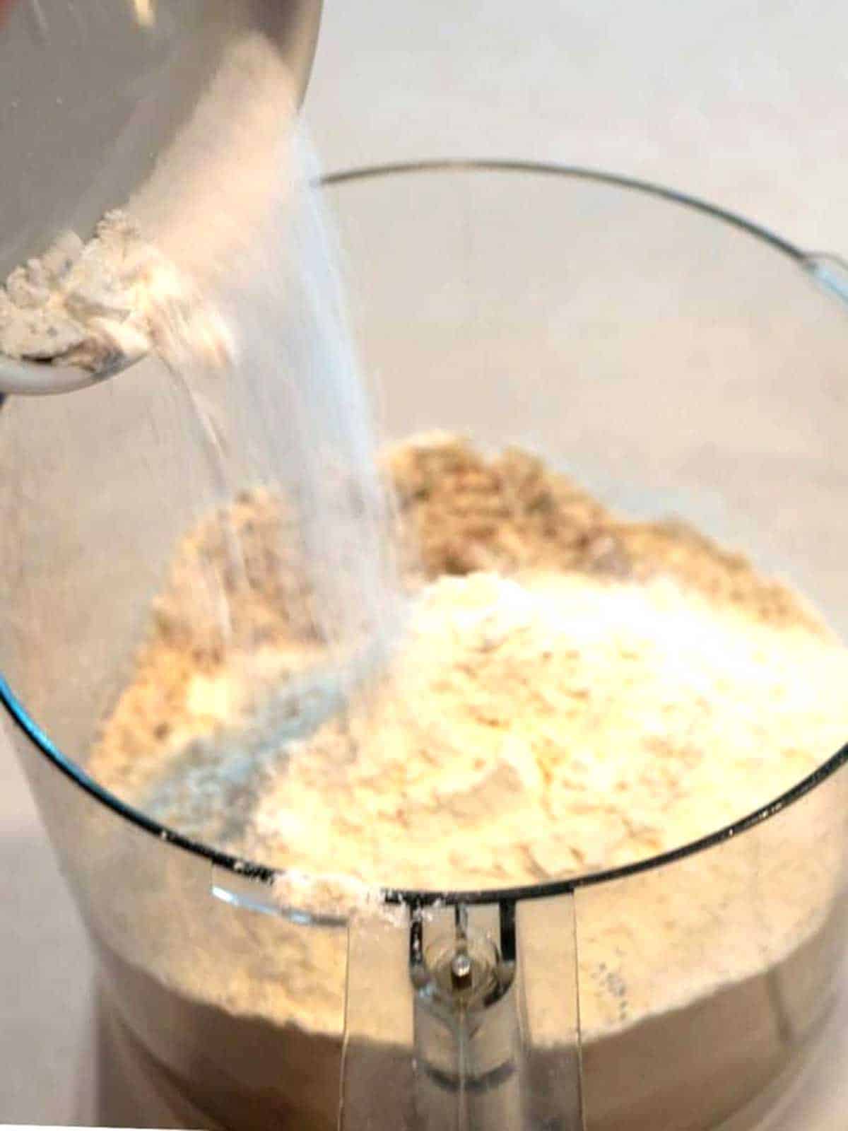 Adding salt to food processor.