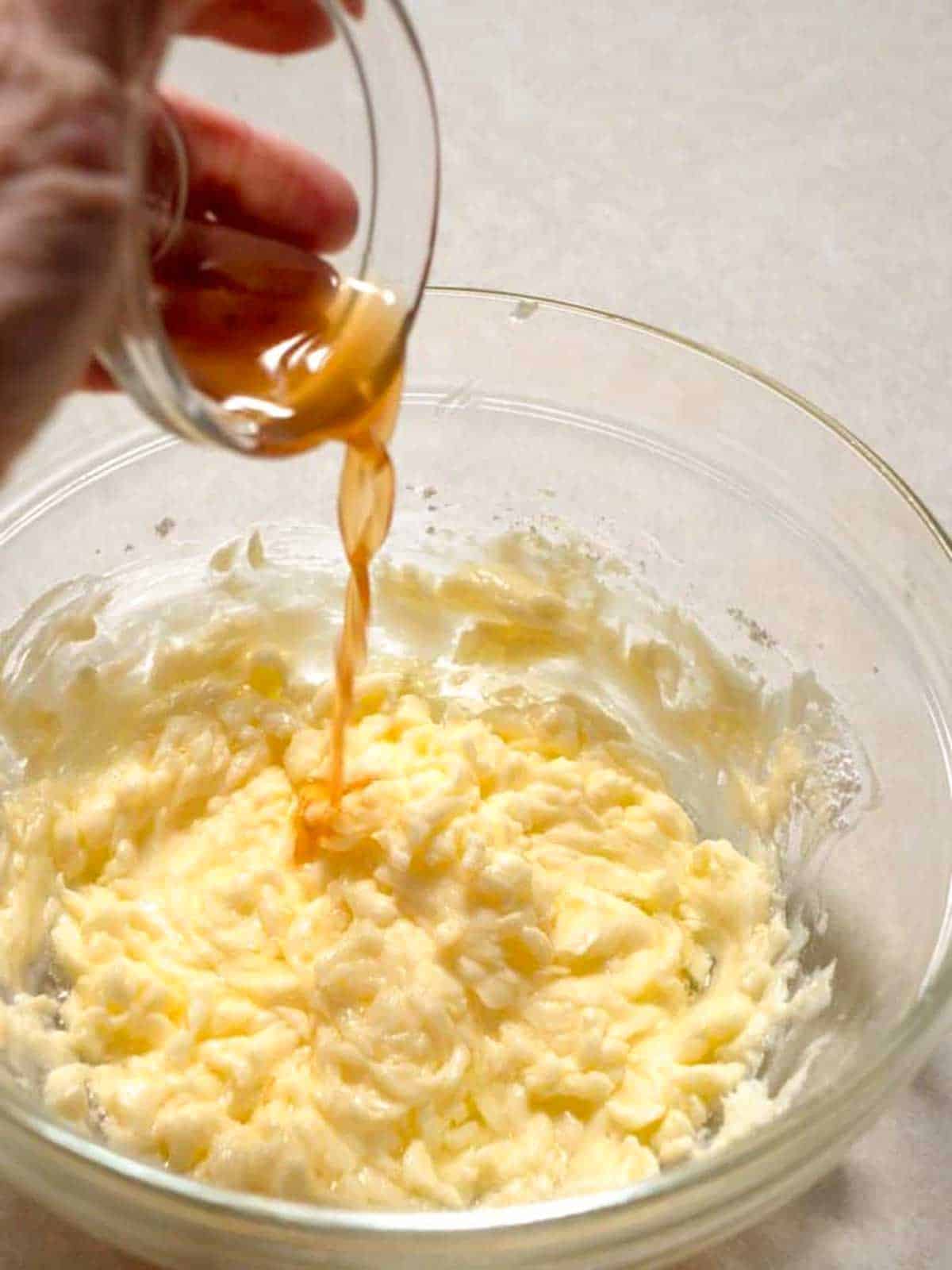 Adding vanilla to the cookie dough.