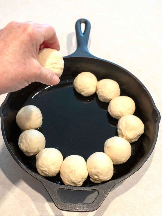 Placing Dough in Cast Iron Pan for Spinach Artichoke Bread Ring Dip