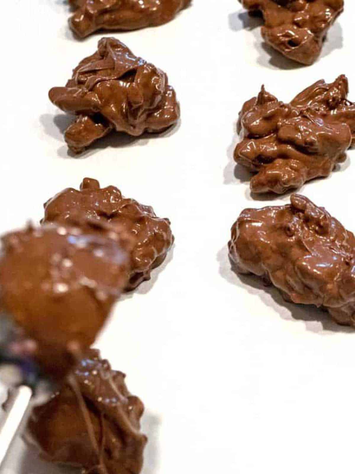 Scooping the candy clusters onto parchment paper.