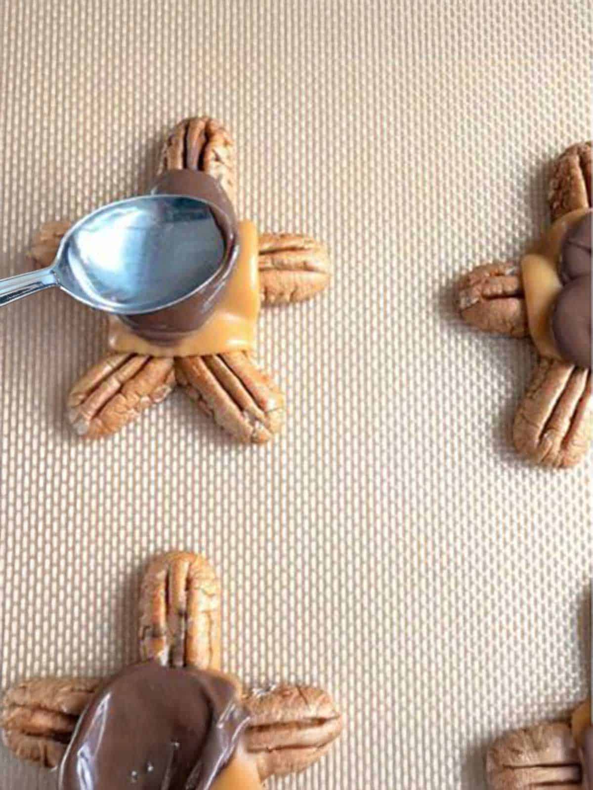 Flattening the melted chocolate with the back of a spoon.