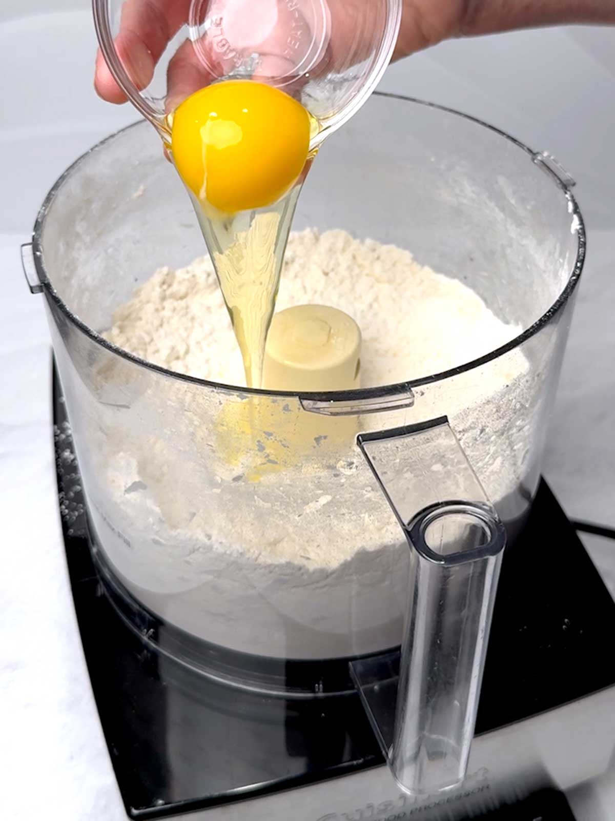 Adding the egg to the Pâte Sucrée mixture.