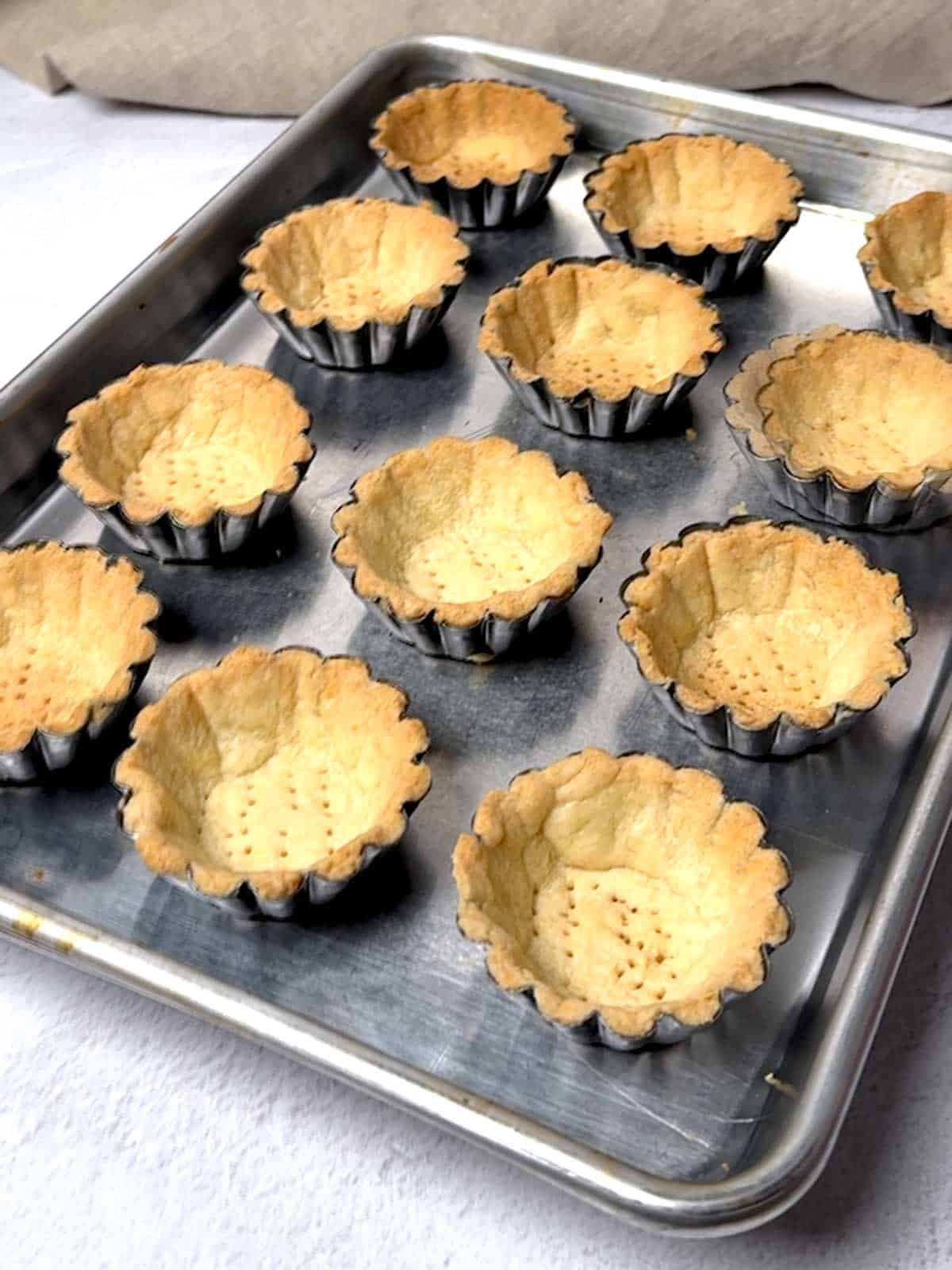 Mini tart shells out of the oven.