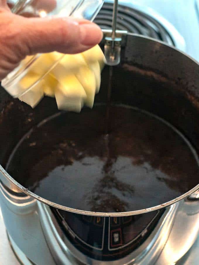 Adding the butter to the fudge mixture
