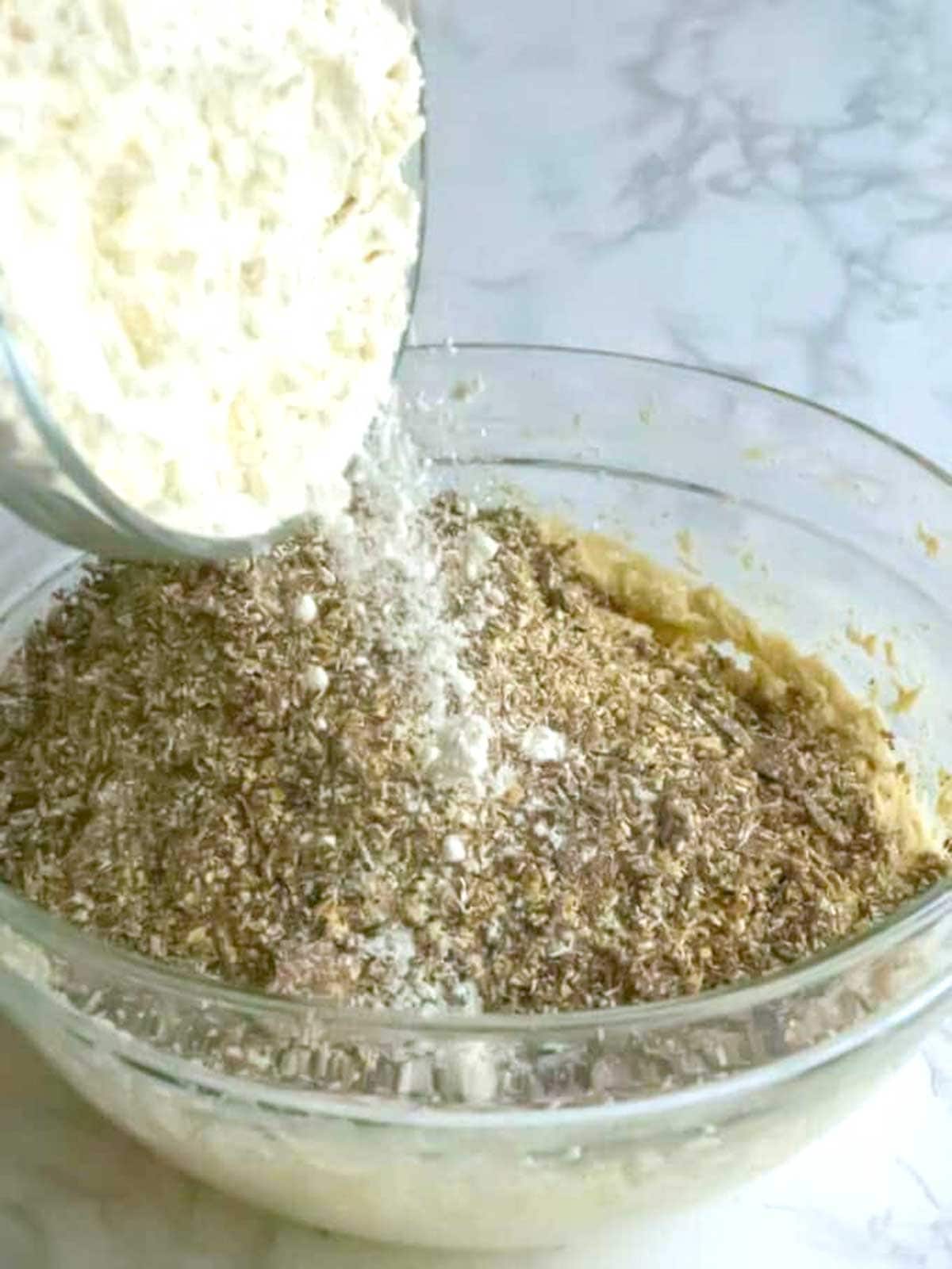 Adding flour to the cookie dough.