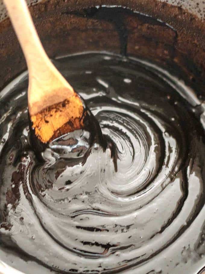 Beating Old-Fashioned Chocolate Fudge Mixture with Wooden Spoon