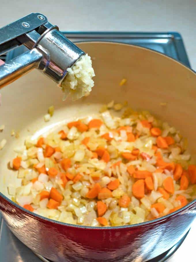 Adding Garlic to Onions and Carrots