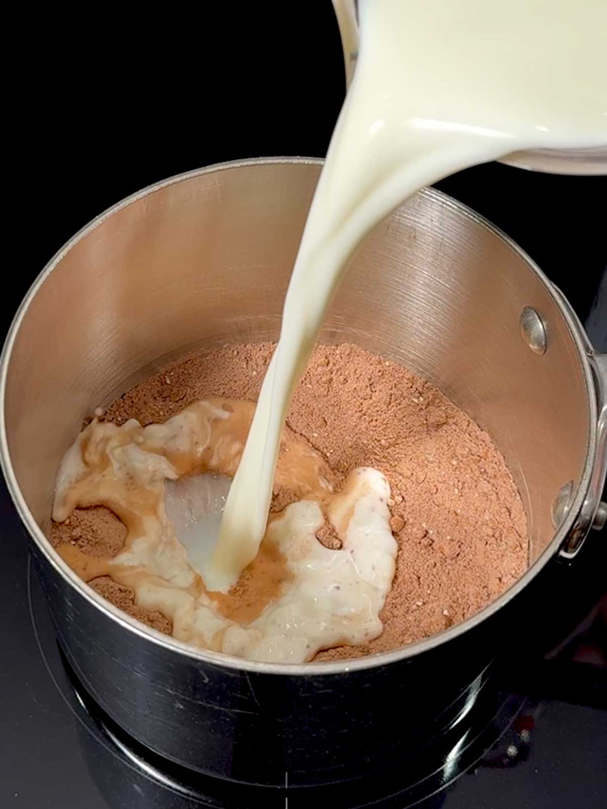 Adding milk to the dry ingredients.