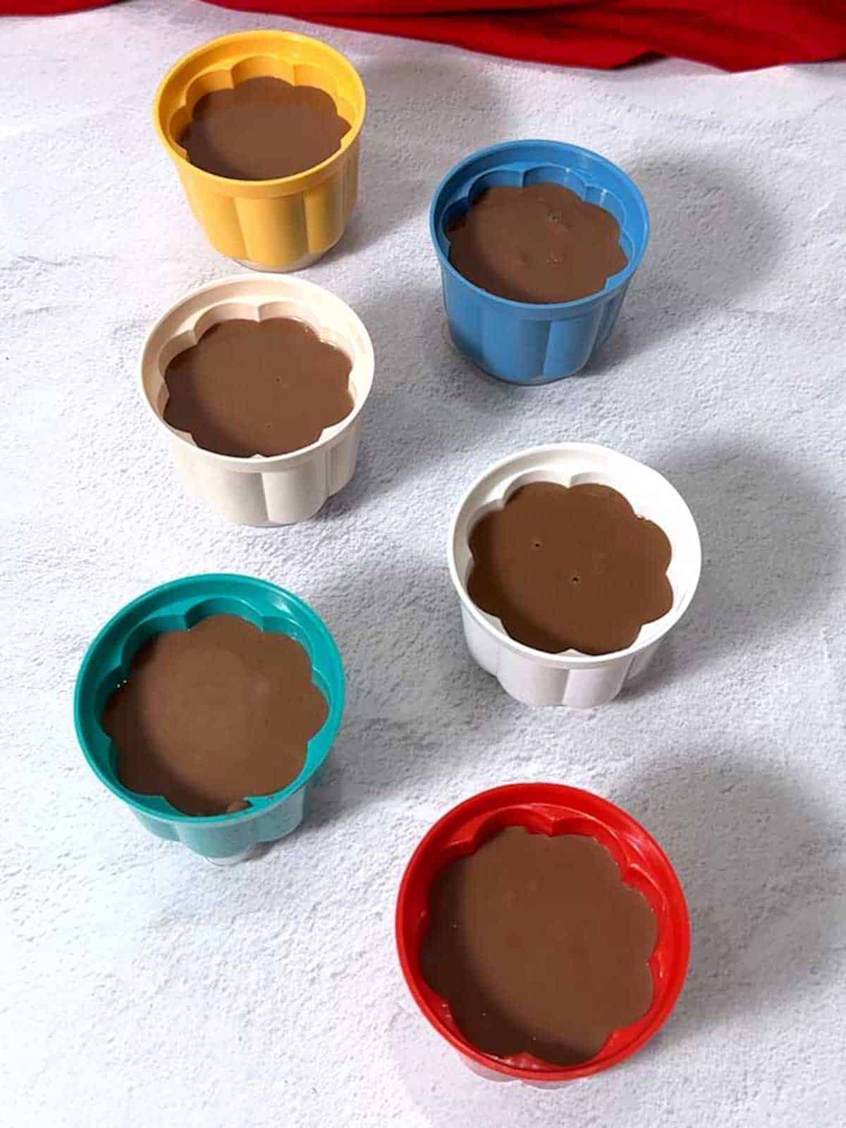 Molds filled with chocolate blancmange.