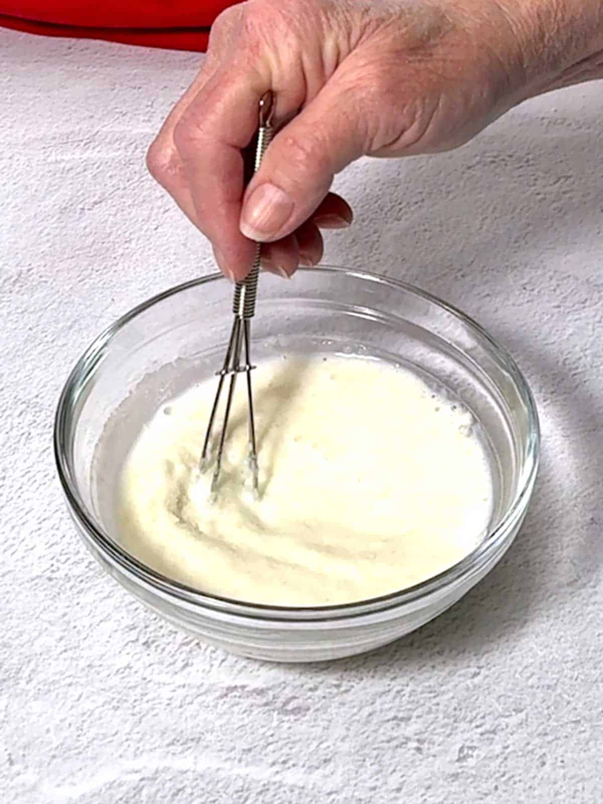 Whisking the gelatin in the milk.