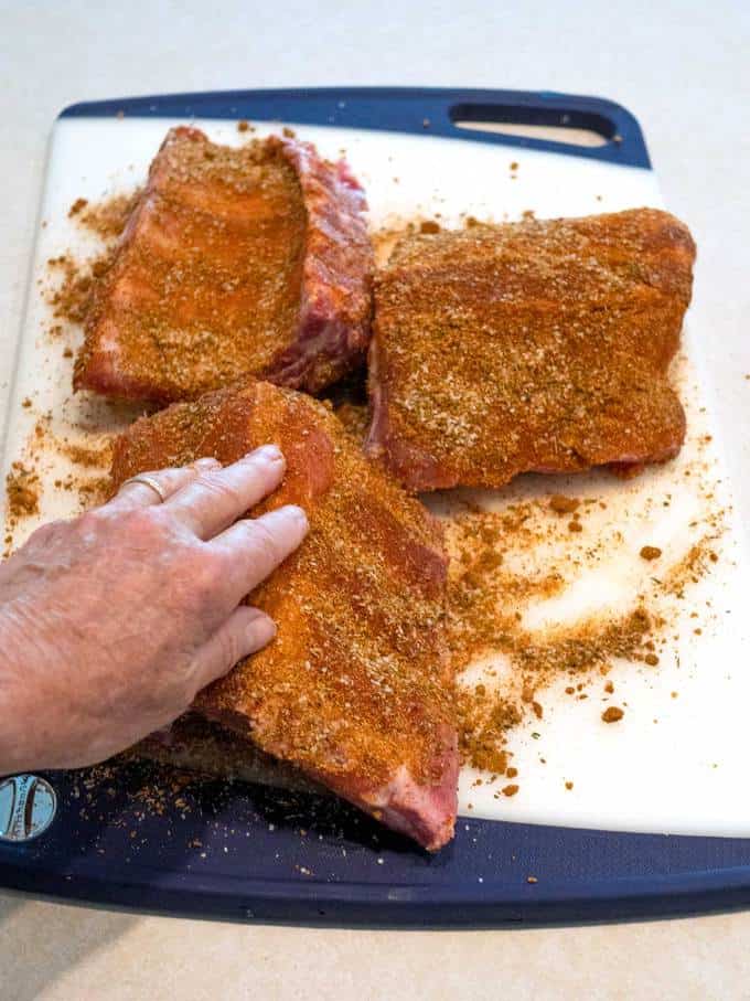 Applying Dry Rub to Baby Back Ribs