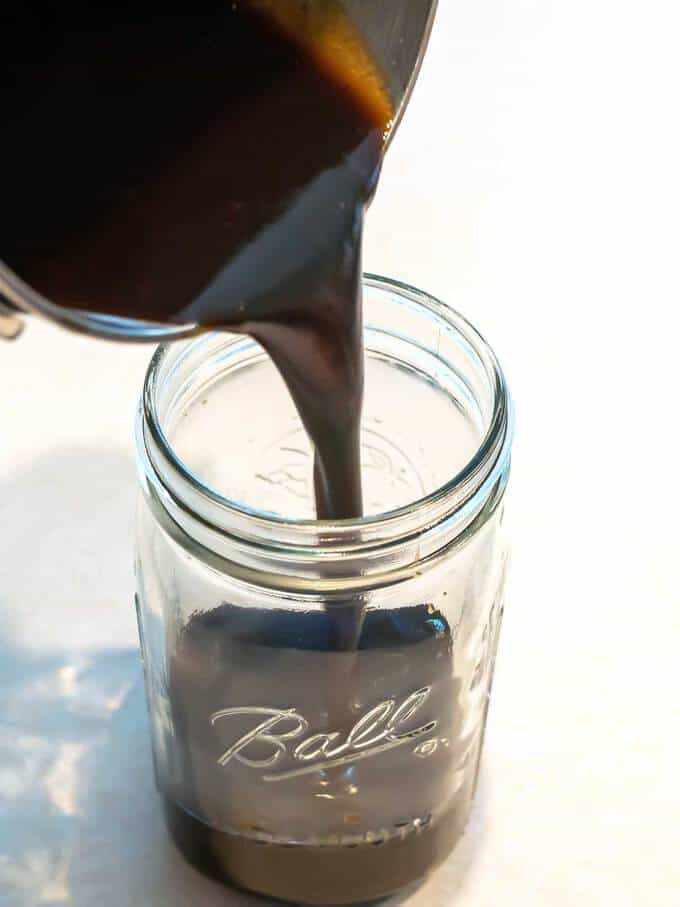 Pouring Balsamic Honey Barbecue Sauce in Jar